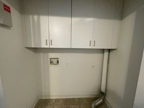 Wilson apartment for rent - A white wall with a red sign and a white pipe.