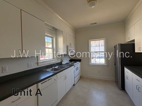 Wilson apartment for rent - A kitchen with white cabinets and black countertops is labeled "Unit A.".