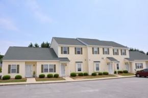 Wilson apartment for rent - A two-story house with a grey roof and white walls.