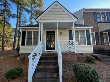 Wilson apartment for rent - A house with a front porch and stairs leading up to the door.