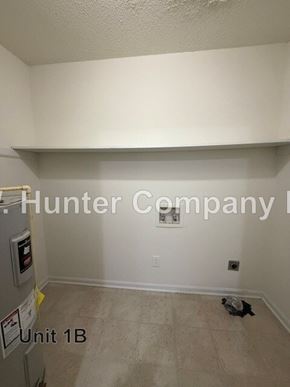 Wilson apartment for rent - A room with a white ceiling and a white wall with a sign that says Hunter Company.