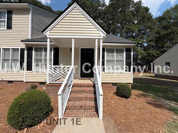 Wilson apartment for rent - A house with a front porch and a sign that says "Unit 1E".