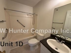Wilson apartment for rent - A bathroom with a sink, toilet, and bathtub.