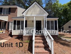 Wilson apartment for rent - A house with a white front porch and a sign that says "Unit 1D" in front of it.