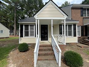 Wilson apartment for rent - A small house with a front porch and stairs leading up to the door.