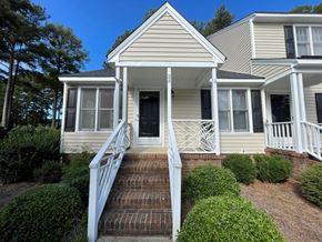 Wilson apartment for rent - A house with a front porch and stairs leading to the door.