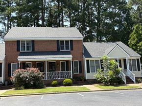 Wilson apartment for rent - A two-story house with a brick facade and a white porch.
