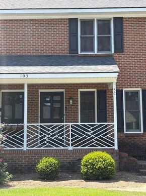 Wilson apartment for rent - House number 103 has a black front door and a white porch.