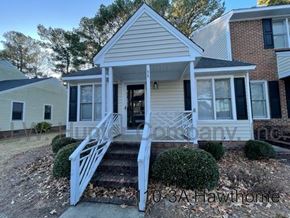 Wilson apartment for rent - A small house with a front porch and stairs leading up to it.