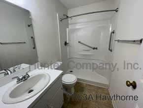 Wilson apartment for rent - A white bathroom with a sink, toilet and bathtub.