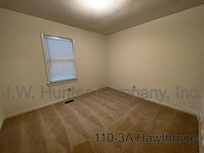 Wilson apartment for rent - A room with a window and carpeting, with the address 110-3A Hawthorne.