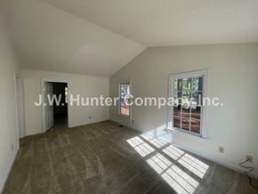 Wilson apartment for rent - A room with carpeted floor and a window letting in sunlight.