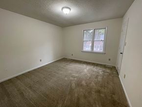 Wilson apartment for rent - A room with a window and carpeted floor.