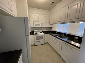 Rocky Mount apartment for rent - A kitchen with white cabinets and appliances.
