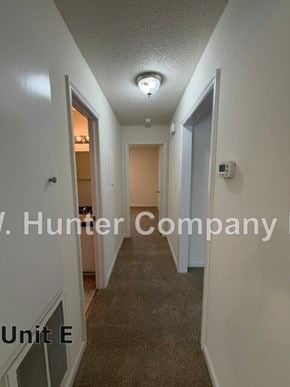 Wilson apartment for rent - A hallway in a building with the words Hunter Company Unit E on the wall.