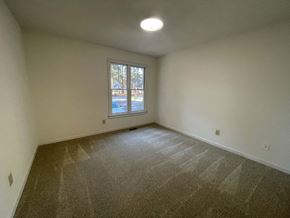 Wilson apartment for rent - A room with a carpeted floor and a window.