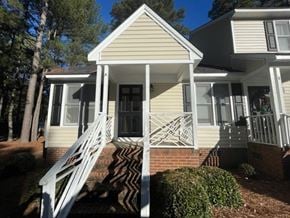 Wilson apartment for rent - A house with a white porch and stairs leading to the front door.