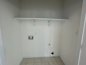 Wilson apartment for rent - A small, empty room with a white wall and tile floor.