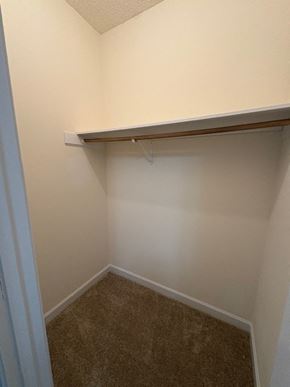 Wilson apartment for rent - A small, empty room with a carpeted floor and a white wall.