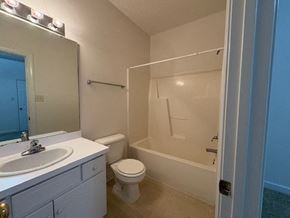 Wilson apartment for rent - A white bathroom with a toilet, sink, and bathtub.
