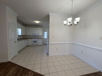 Wilson apartment for rent - A kitchen with white cabinets and a white oven.
