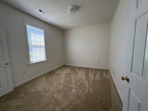 Wilson apartment for rent - A room with carpeted floor and a window letting in light.