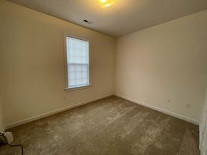 Wilson apartment for rent - A room with a carpeted floor and a window.