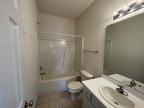 Wilson apartment for rent - A bathroom with a toilet, sink, and bathtub.