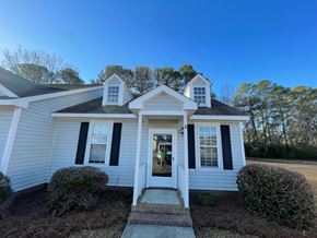 Wilson apartment for rent - A white house with a black roof and a front porch.
