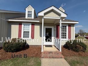 Wilson apartment for rent - A house with red shutters and a sign that says "Unit B".