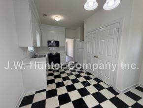 Wilson apartment for rent - A black and white checkered floor in a room with white walls.