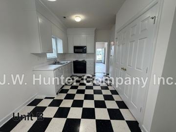 Wilson apartment for rent - A black and white checkered floor in a white kitchen.