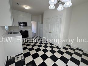 Wilson apartment for rent - A black and white checkered floor in a white room.