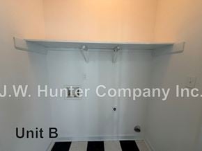 Wilson apartment for rent - A white wall with a shelf and J.W. Hunter Company Inc. written on it.
