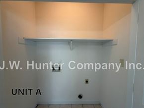Wilson apartment for rent - A white wall with a shelf and J.W. Hunter Company Inc. on it.