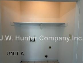 Wilson apartment for rent - A white wall with a shelf and J.W. Hunter Company Inc. on it.