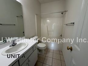 Wilson apartment for rent - A bathroom with a toilet, sink, and shower.
