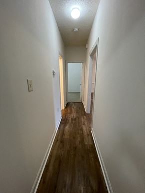 Wilson apartment for rent - A long hallway with wood floors and white walls.