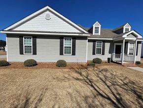 Wilson apartment for rent - A house with a grey siding and a white roof.