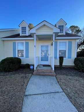 Wilson apartment for rent - A house with a blue door and a small porch.