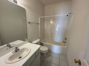 Wilson apartment for rent - A white bathroom with a sink, toilet and bathtub.