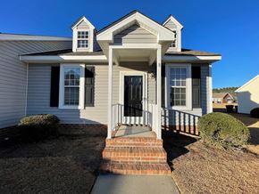 Wilson apartment for rent - A house with a grey siding and a black door.