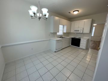 Wilson apartment for rent - A kitchen with white cabinets and appliances.