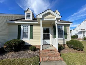 Wilson apartment for rent - A house with a white door and green shutters.