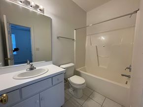 Wilson apartment for rent - A bathroom with a white sink, toilet, and bathtub.