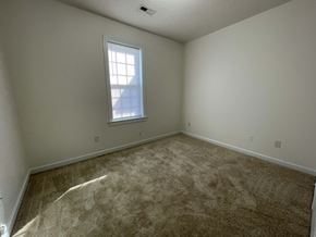 Wilson apartment for rent - A room with a carpeted floor and a window.
