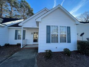 Rocky Mount apartment for rent - A white house with a black roof and a grey door.