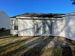 Rocky Mount apartment for rent - A white house with a grey roof and a grey concrete walkway in front.