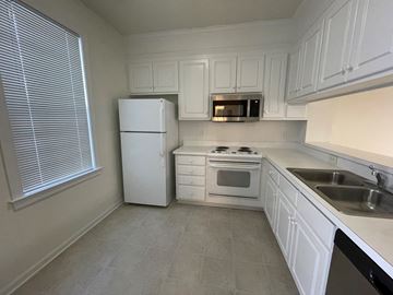 Rocky Mount apartment for rent - A kitchen with white appliances and cabinets.