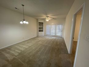 Rocky Mount apartment for rent - A room with a carpeted floor and a ceiling fan.